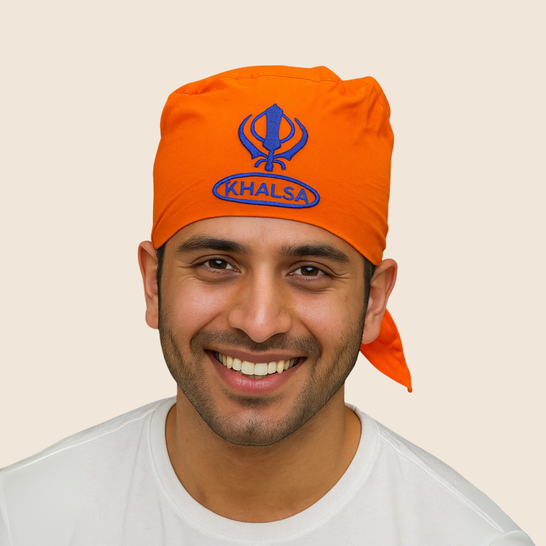 Man wearing an orange 'Khalsa' headscarf on a beige background