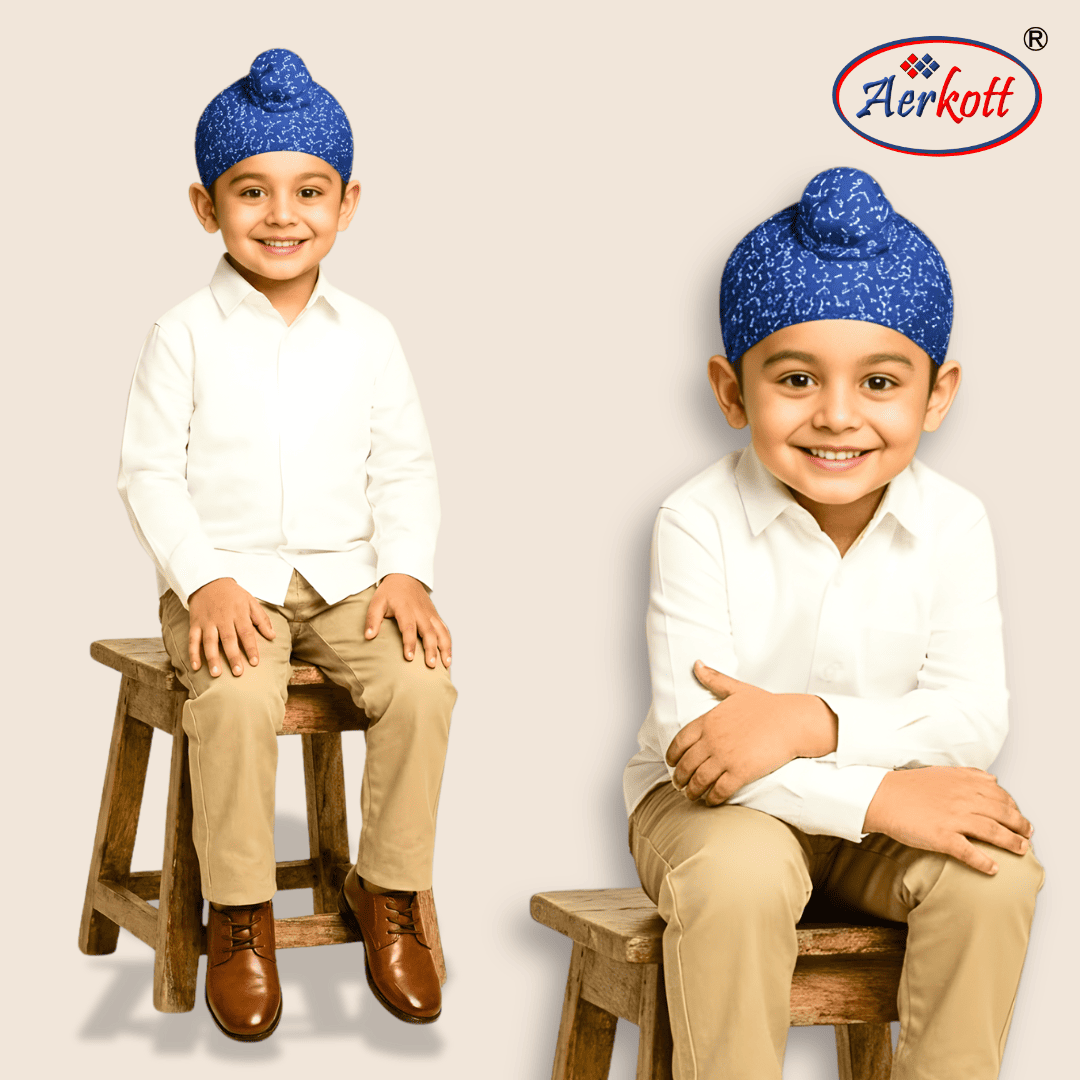 Two children wearing blue turbans and white shirts with the Aerkott logo.