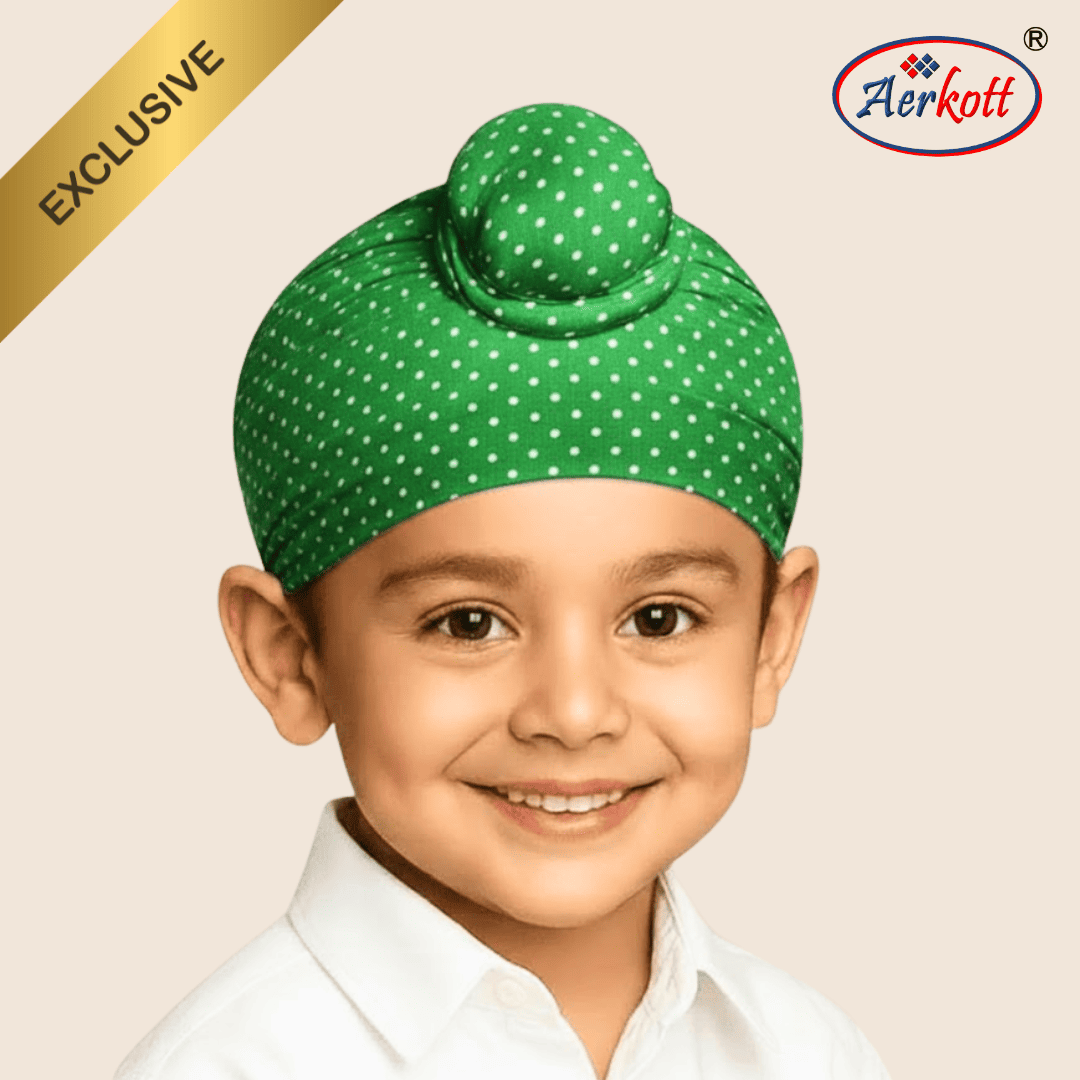 Child wearing a green polka dot turban with Aerkott branding on a beige background