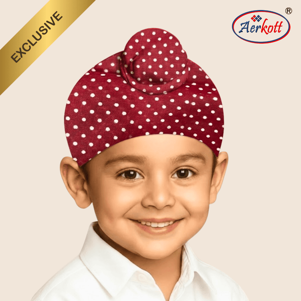 Child wearing a red polka dot turban with Aerkott branding on a beige background