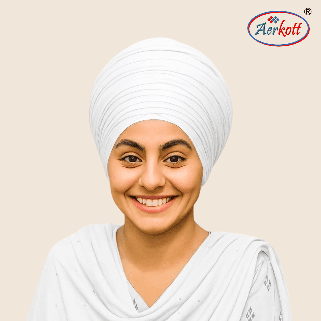 Person wearing a white mulmul malmal turban with AERKOTT logo in the corner