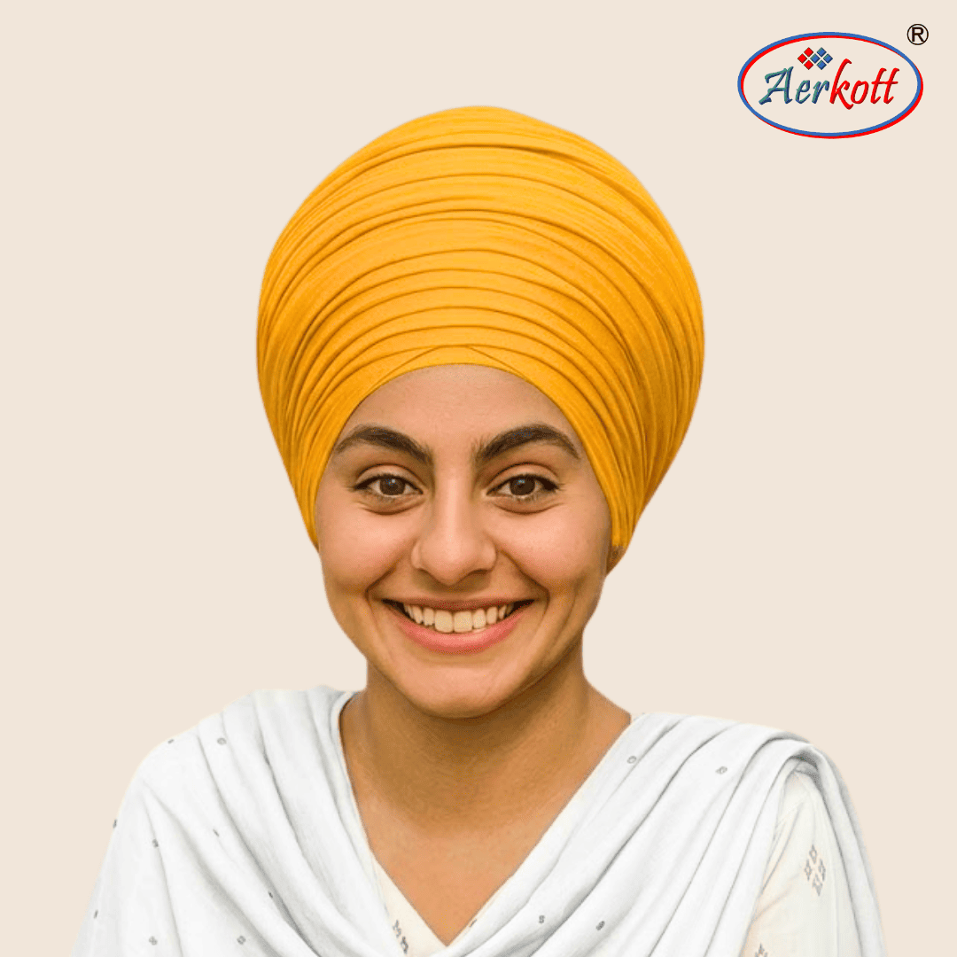 Woman wearing a yellow mulmul malmal turban with AERKOTT logo in the corner
