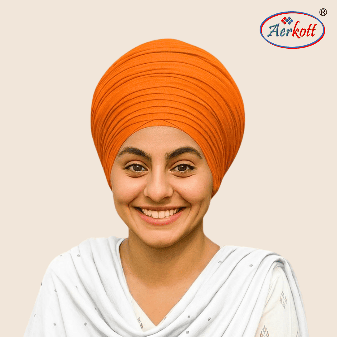 Person wearing an orange turban with a visible brand logo in the corner