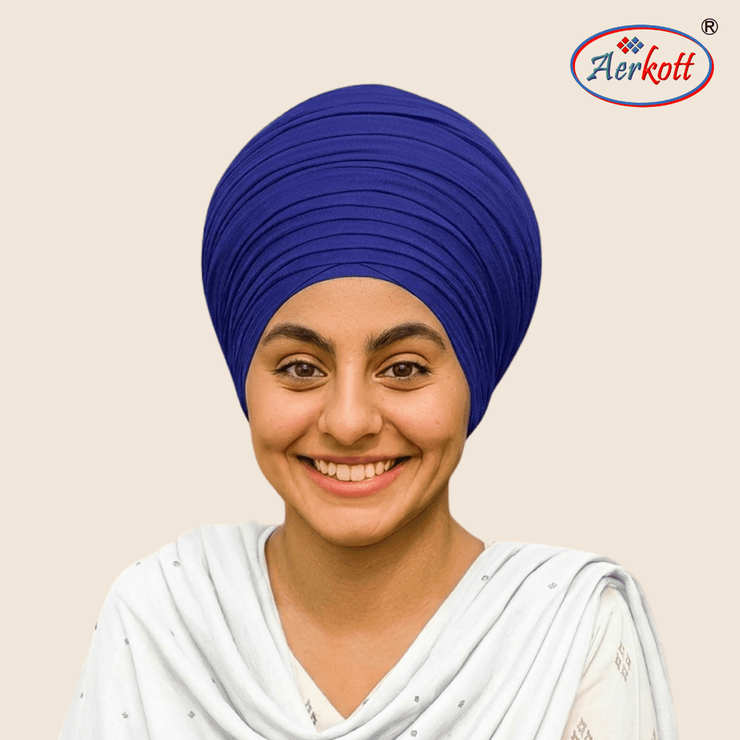Woman wearing a blue mulmull malmal turban with AERKOTT logo in the corner
