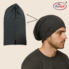 Dark gray beanie on a man's head with Aerkott logo, next to an unfolded beanie.