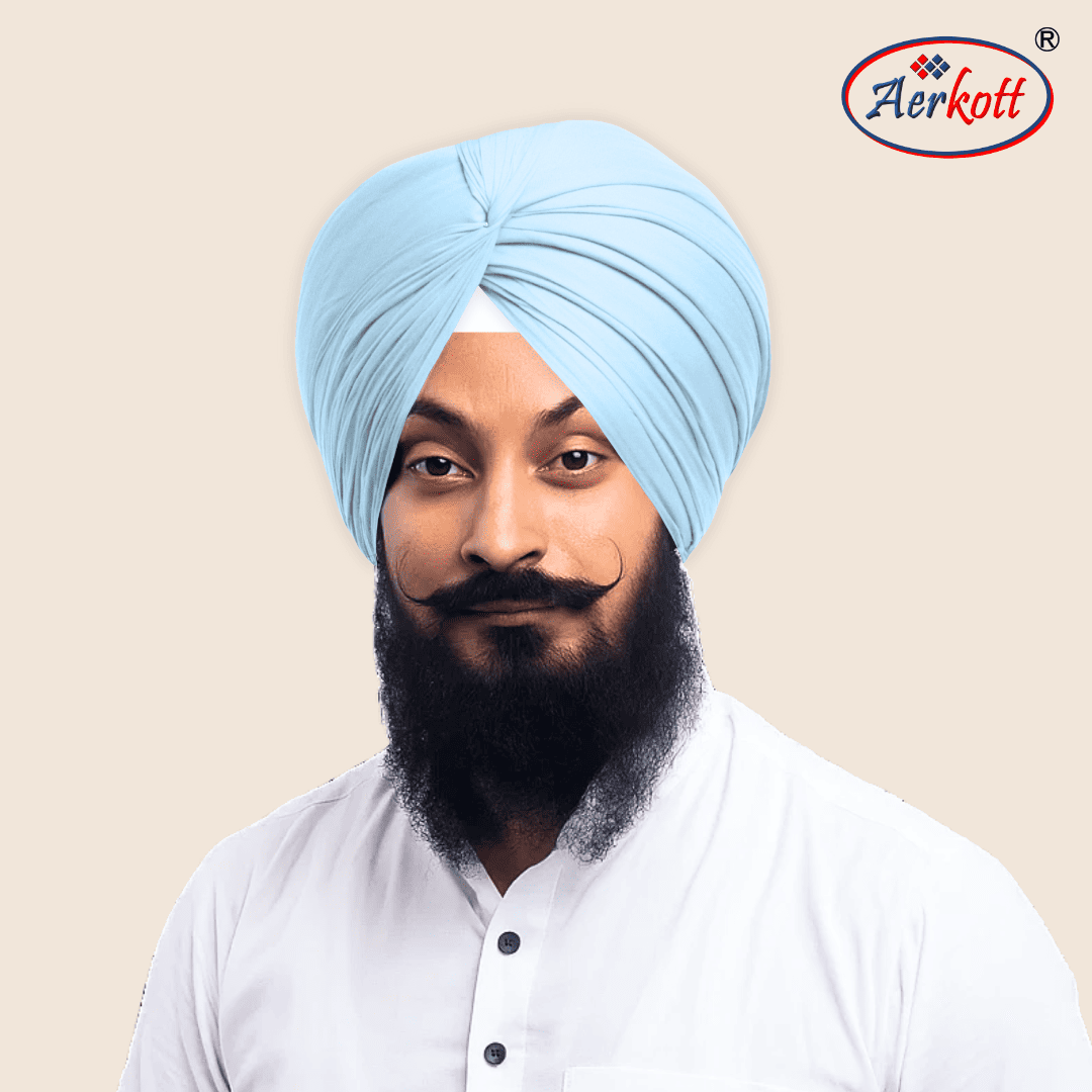 Man wearing a light blue turban with Aerkott logo in the corner