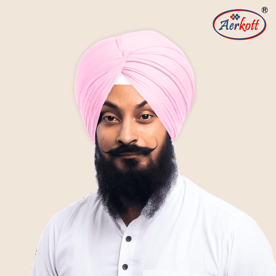 Man wearing a pink turban with Aerkott logo in the corner