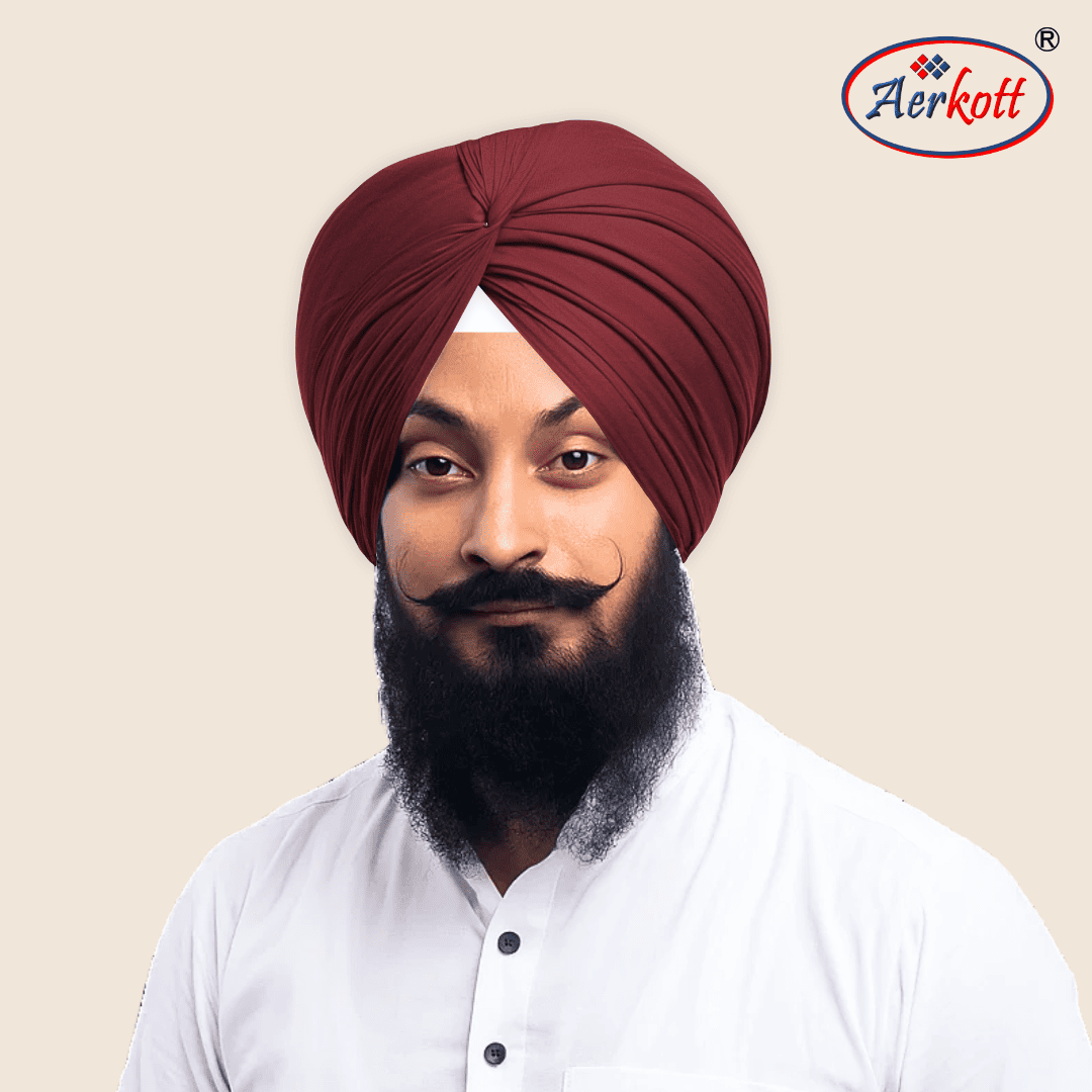 Man wearing a red turban with Aerkott logo in the corner