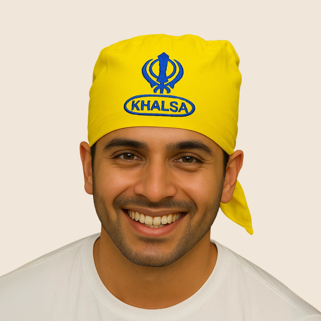 Man wearing a yellow headscarf with 'Khalsa' text on a beige background