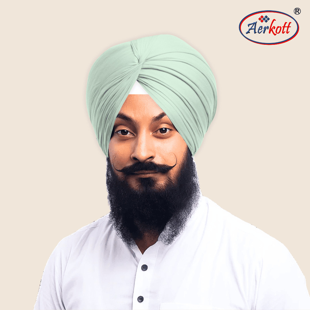 Man wearing a light green turban with Aerkott logo in the corner