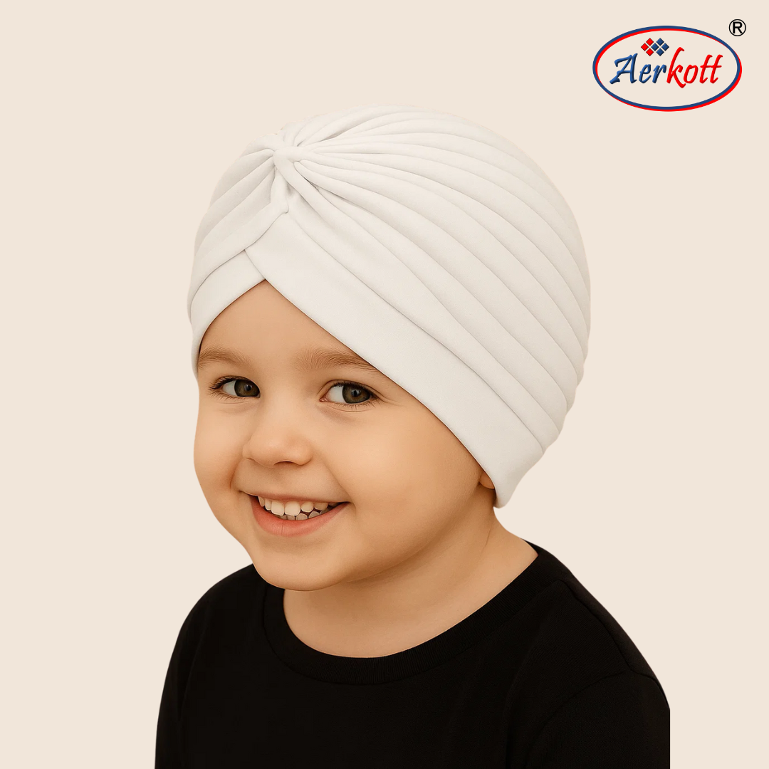 Child wearing a white turban with Aerkott logo in the corner