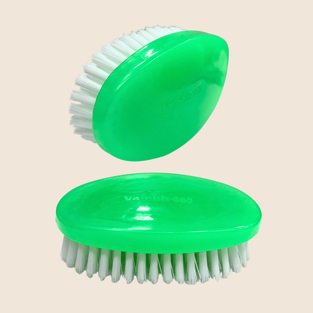 Two green beard brushes with white bristles on a beige background