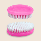 Two pink beard brushes with white bristles on a beige background